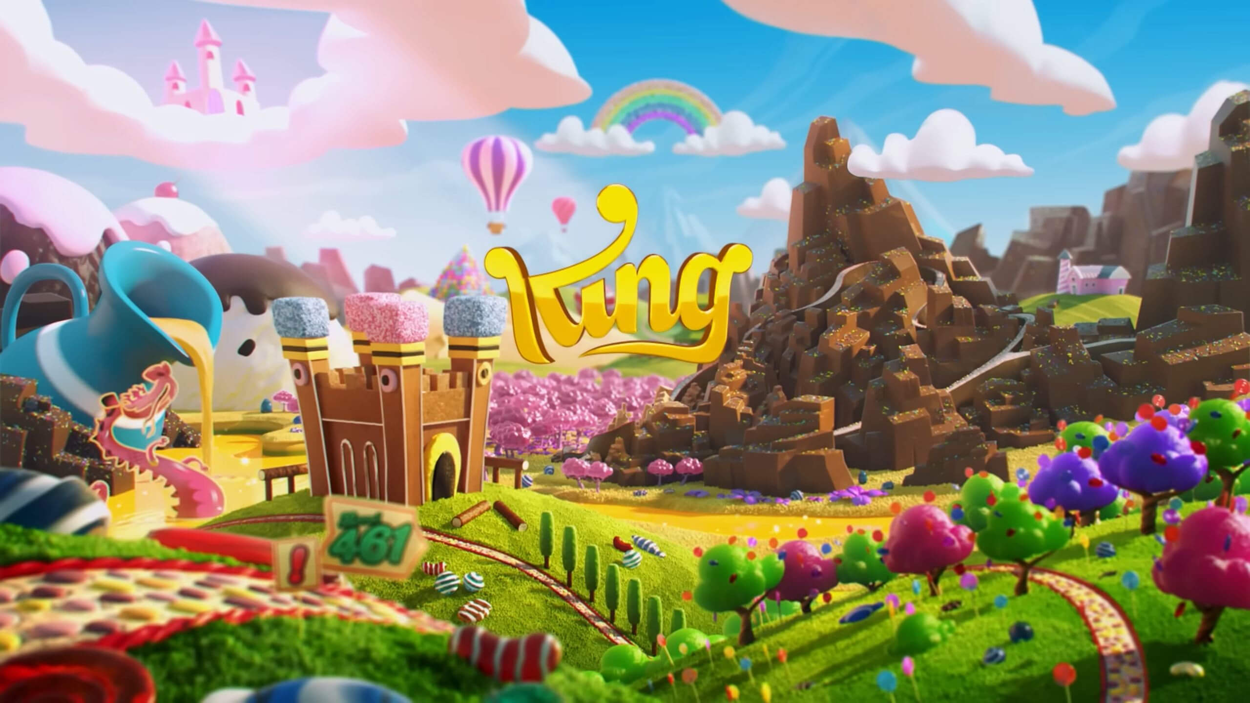 The King logo against a backdrop of a cartoon-like idyllic landscape